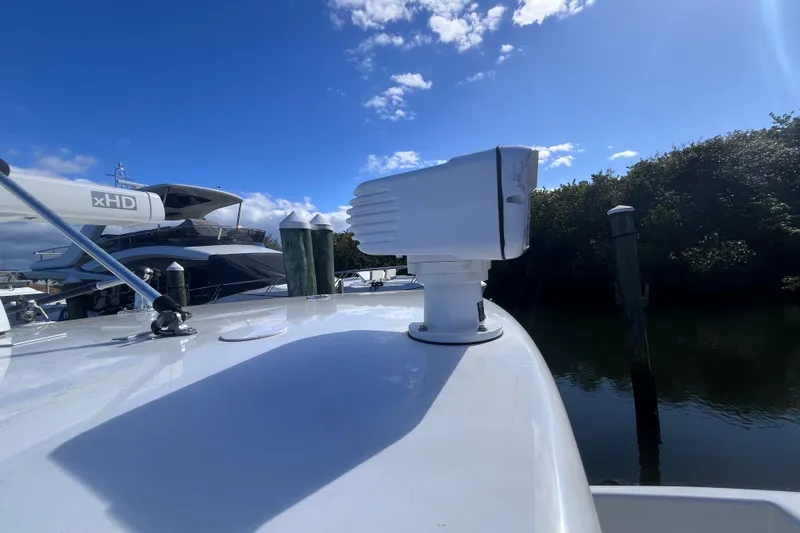 Slide: The Image of 2008 Intrepid 370 Cuddy boat with rod holders, docked under clear blue sky. - 54