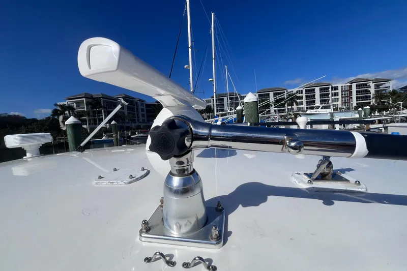 Slide: The Image of 2008 Intrepid 370 Cuddy with Garmin radar, docked under clear blue sky. - 56