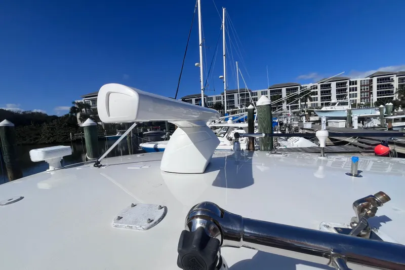 Slide: The Image of 2008 Intrepid 370 Cuddy boat deck with marina background, clear blue sky. - 57