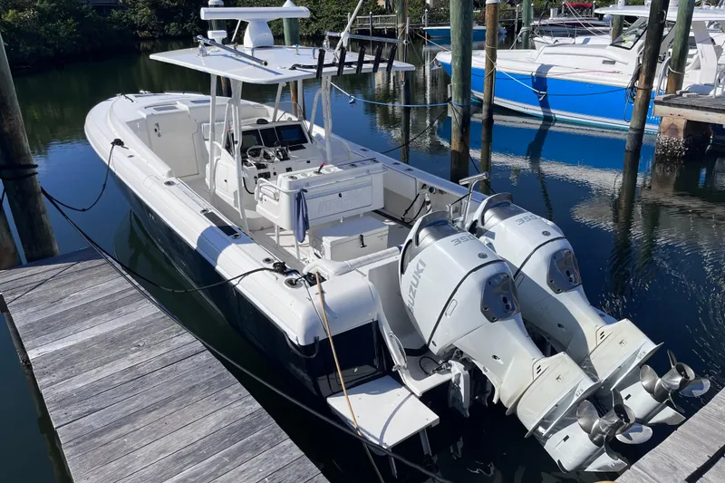 Slide: The Image of 2008 Intrepid 370 Cuddy boat docked with twin outboard engines. - 6