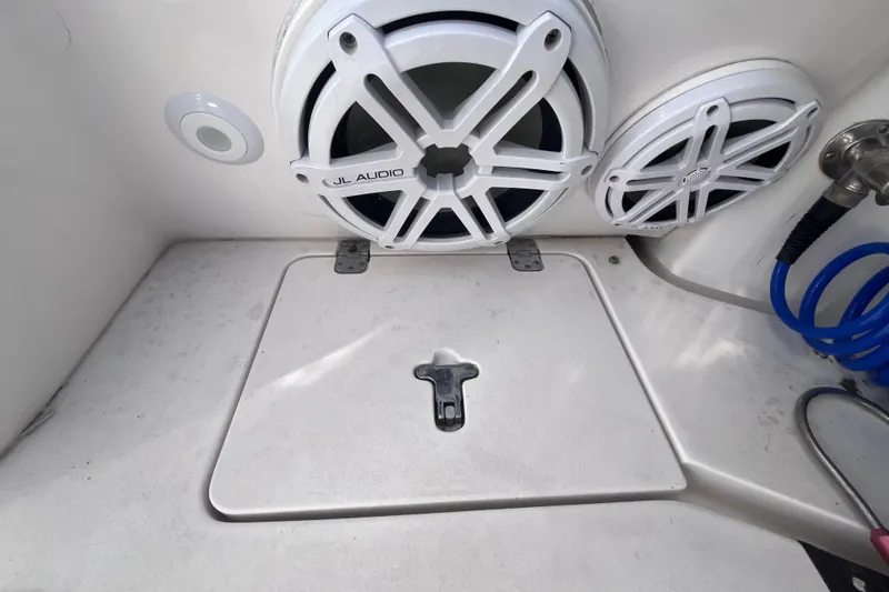 Slide: The Image of Storage compartment with yellow cables on a 2008 Intrepid 370 Cuddy boat. - 64