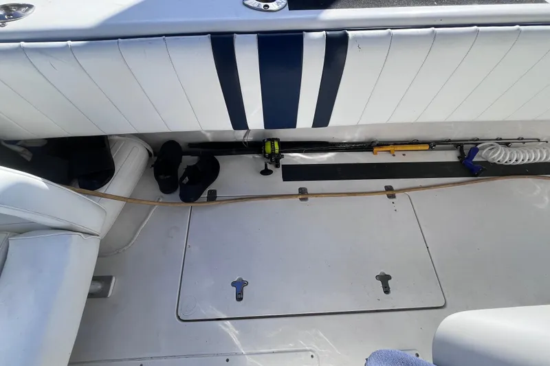 Slide: The Image of Storage compartment on a 2008 Intrepid 370 Cuddy boat with equipment and supplies. - 68