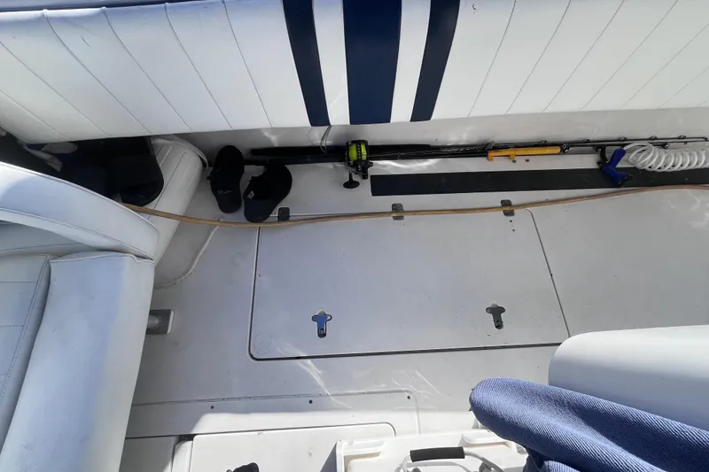 Slide: The Image of 2008 Intrepid 370 Cuddy boat interior with fishing gear and white seating. - 69