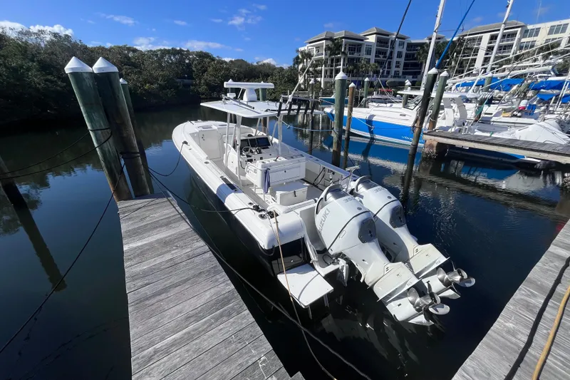 Slide: The Image of 2008 Intrepid 370 Cuddy boat docked, featuring dual Suzuki outboard engines. - 7