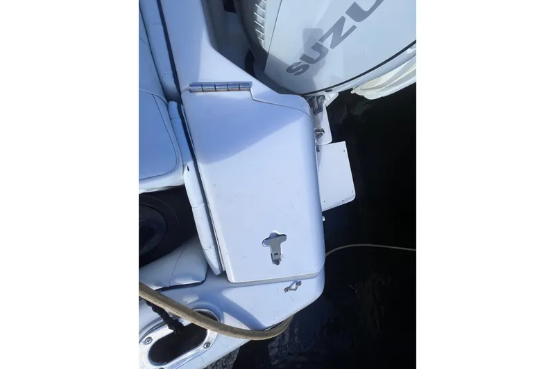 Slide: The Image of Open storage compartment on 2008 Intrepid 370 Cuddy boat, near water. - 76