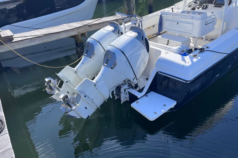 Slide: The Image of 2008 Intrepid 370 Cuddy boat docked in marina, clear sky, calm water. - 8