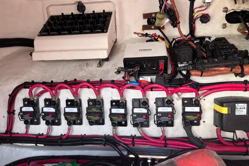 Slide: The Image of Electrical wiring system inside a 2008 Intrepid 370 Cuddy boat, showcasing organized cables and connectors. - 86