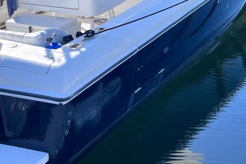 Slide: The Image of 2008 Intrepid 370 Cuddy boat with dual outboard engines docked in marina. - 9