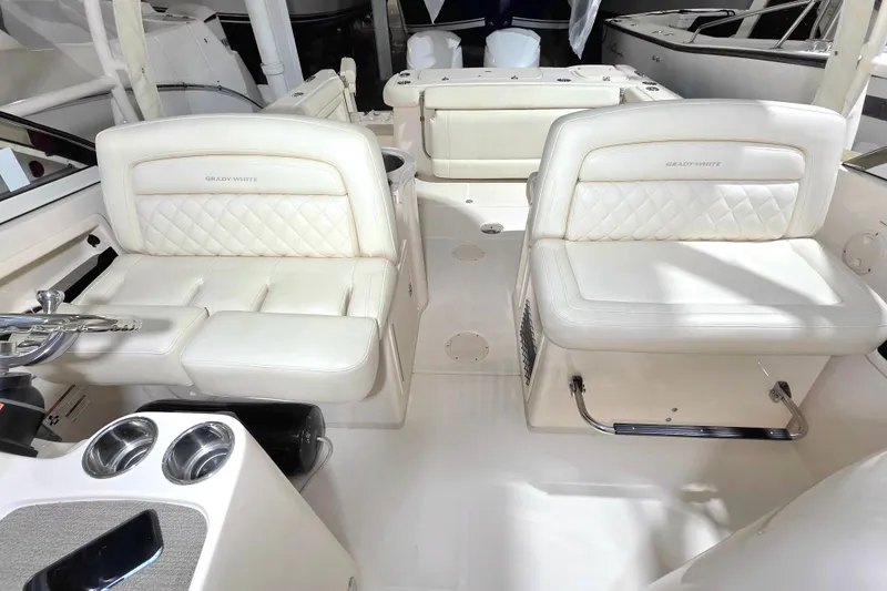 Slide: The Image of 2019 Grady-White Freedom 307 boat interior with luxurious white seating. - 16