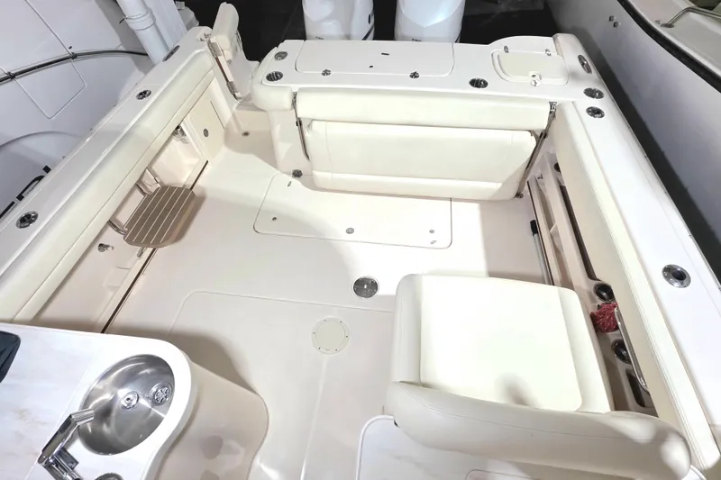 Slide: The Image of 2019 Grady-White Freedom 307 boat interior with seating and sink. - 17