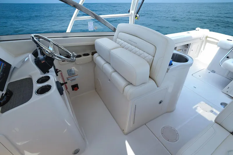 Slide: The Image of Manufacturer Provided Image: 2019 Grady-White Freedom 307 boat interior with helm and seating, ocean view. - 2