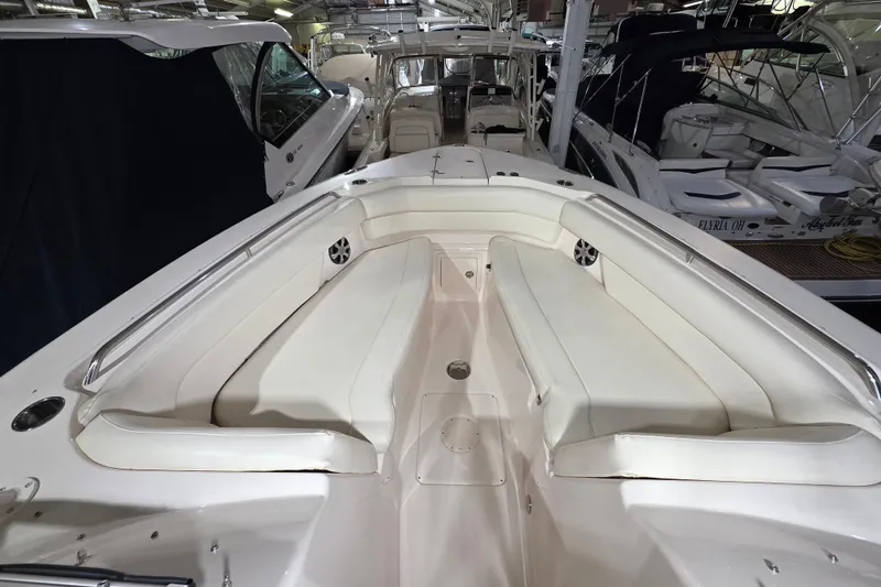 Slide: The Image of 2019 Grady-White Freedom 307 boat interior with white seating in a marina. - 9