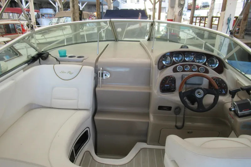 Slide: The Image of 2001 Searay 280 Sundancer boat cockpit with steering wheel and instrument panel. - 15