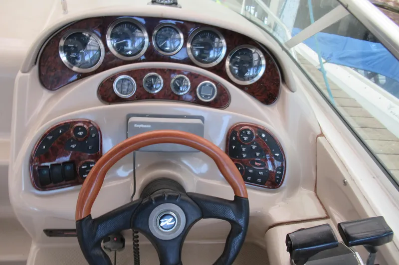 Slide: The Image of 2001 Searay 280 Sundancer dashboard with gauges and steering wheel. - 16