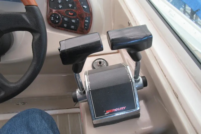 Slide: The Image of Throttle controls on a 2001 Searay 280 Sundancer boat dashboard. - 17