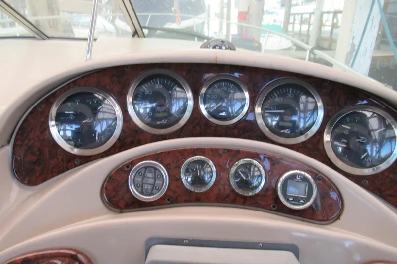 Slide: The Image of Dashboard of a 2001 Searay 280 Sundancer boat with gauges and controls. - 18