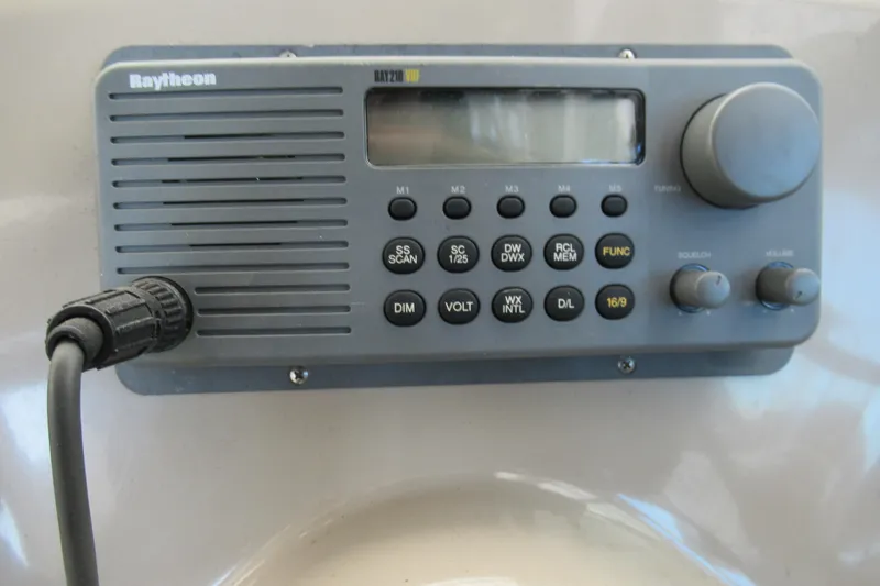 Slide: The Image of Raytheon marine radio on 2001 Searay 280 Sundancer boat dashboard. - 21
