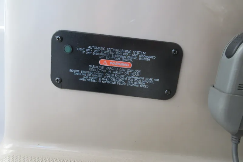 Slide: The Image of 2001 Searay 280 Sundancer automatic extinguishing system warning label. - 24