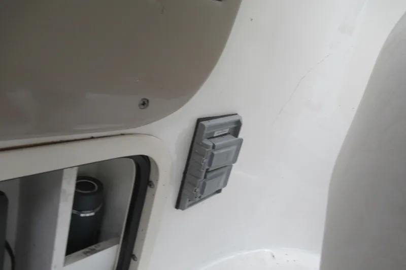 Slide: The Image of 2001 Searay 280 Sundancer interior detail with electrical panel and storage compartment. - 25