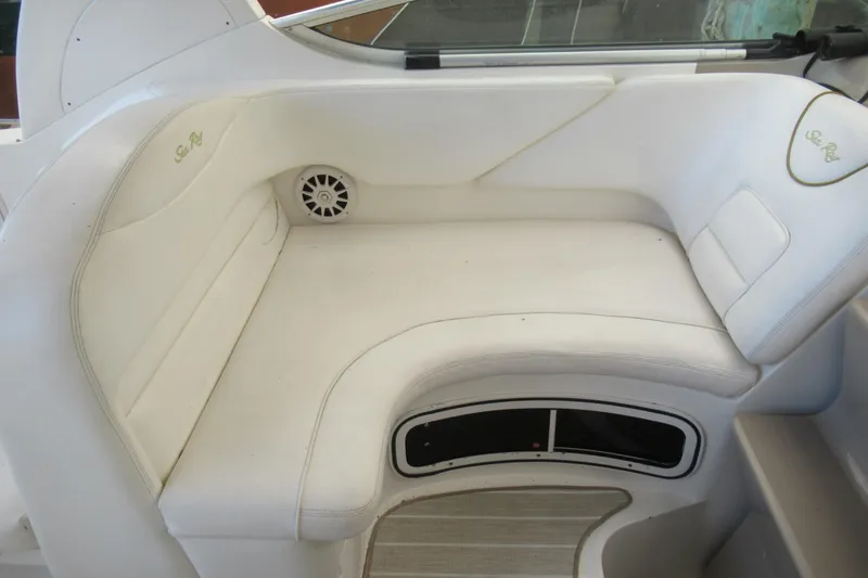 Slide: The Image of 2001 Searay 280 Sundancer boat interior seating with white upholstery and speaker. - 28