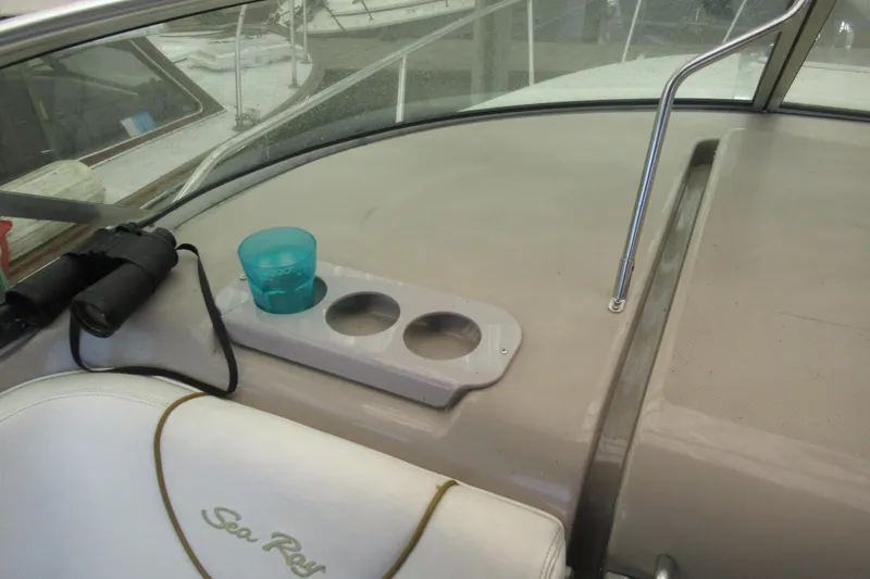Slide: The Image of 2001 Searay 280 Sundancer cockpit with cup holders and binoculars. - 29
