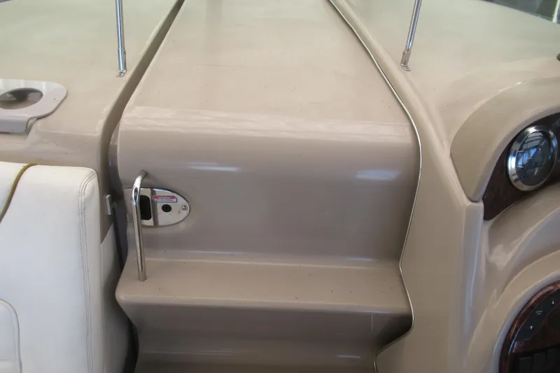 Slide: The Image of 2001 Searay 280 Sundancer boat interior, featuring beige dashboard and seating area. - 30