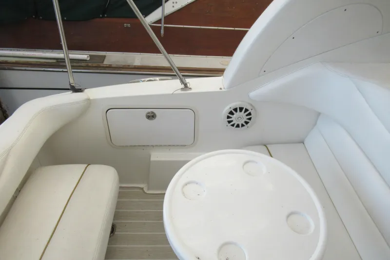 Slide: The Image of 2001 Searay 280 Sundancer boat interior with white seating and round table. - 37