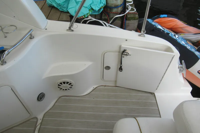 Slide: The Image of 2001 Searay 280 Sundancer boat interior with storage compartment and speaker. - 38