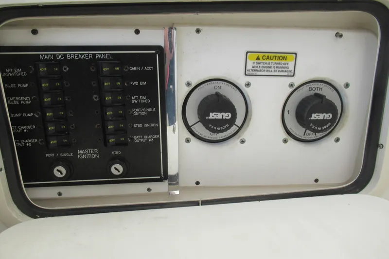Slide: The Image of Control panel of 2001 Searay 280 Sundancer boat with switches and caution label. - 39