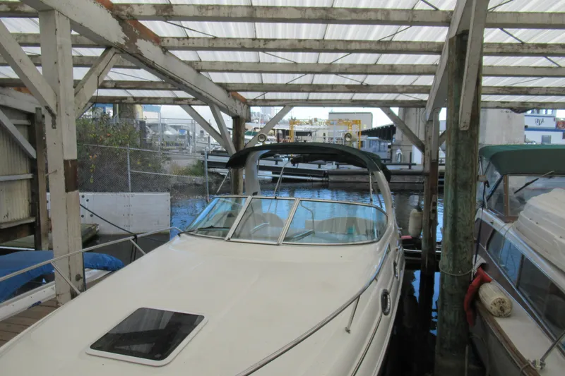 Slide: The Image of 2001 Searay 280 Sundancer docked under a covered marina. - 4