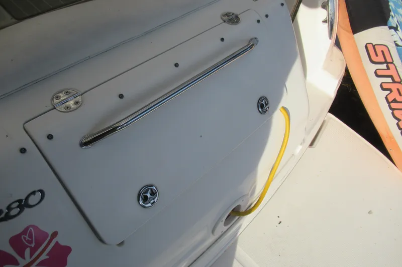 Slide: The Image of 2001 Searay 280 Sundancer boat deck with storage hatch and yellow cable. - 45