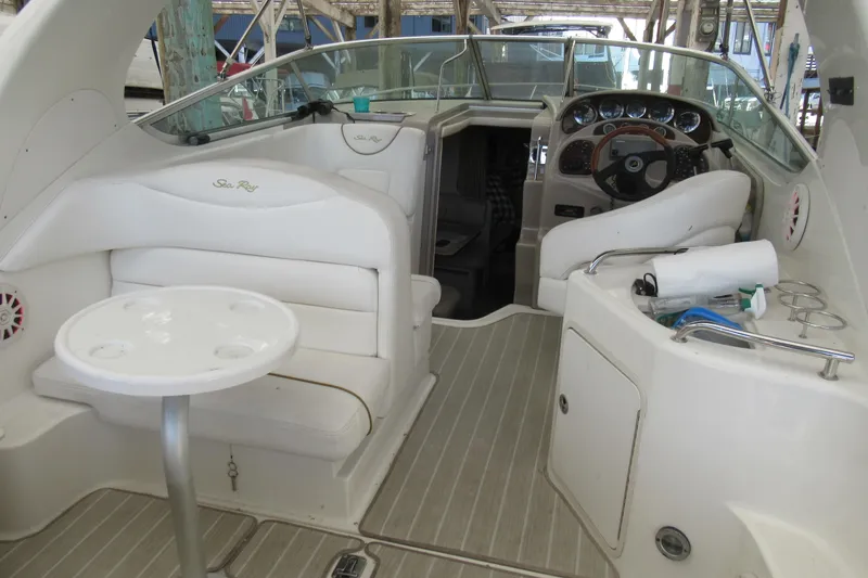 Slide: The Image of 2001 Searay 280 Sundancer boat interior with seating, helm, and table. - 48