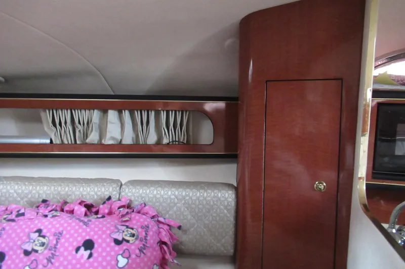 Slide: The Image of Interior of 2001 Searay 280 Sundancer with wood paneling and Minnie Mouse blanket. - 54