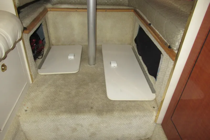Slide: The Image of 2001 Searay 280 Sundancer cabin interior with carpeted flooring and storage compartments. - 57