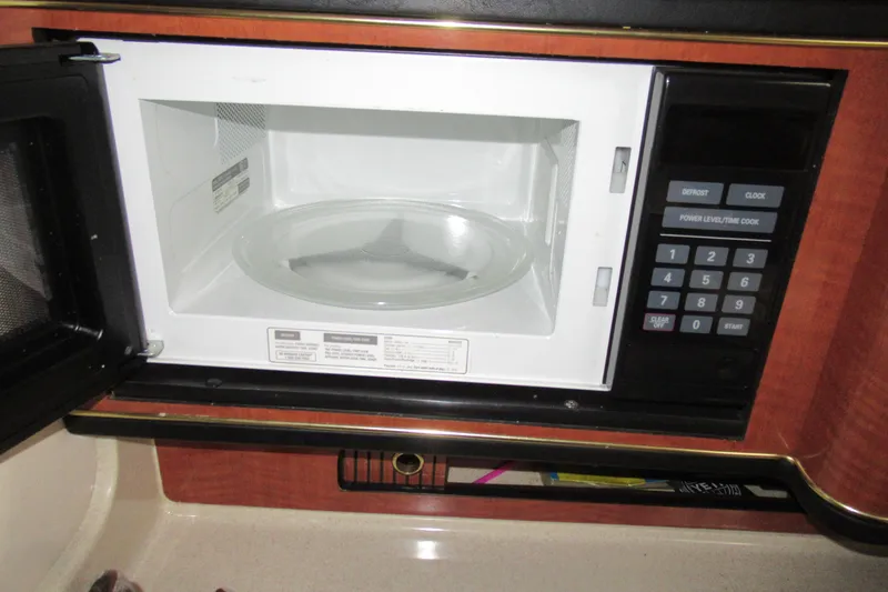 Slide: The Image of Microwave inside 2001 Searay 280 Sundancer boat, open door, keypad visible. - 60