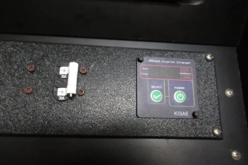 Slide: The Image of KISAE inverter charger panel with 30A fuses on 2001 Searay 280 Sundancer. - 69