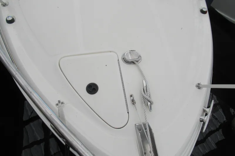 Slide: The Image of Bow of 2001 Searay 280 Sundancer with cleats and rope, docked on calm water. - 7