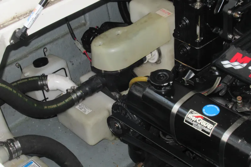 Slide: The Image of Engine compartment of a 2001 Searay 280 Sundancer boat, showing coolant system components. - 72