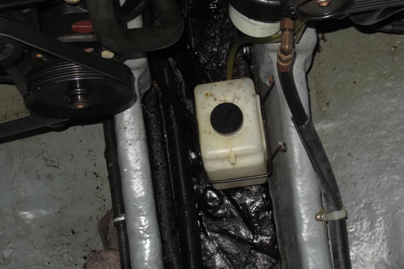 Slide: The Image of Engine compartment of 2001 Searay 280 Sundancer, showing belts and fluid reservoir. - 74