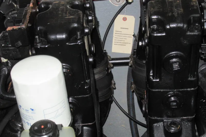Slide: The Image of Engine components of a 2001 Searay 280 Sundancer boat, featuring a warning label. - 75