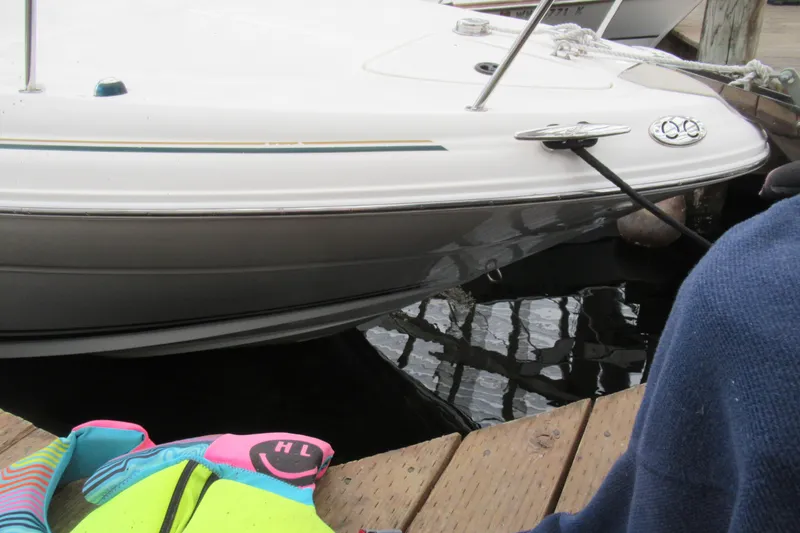 Slide: The Image of 2001 Searay 280 Sundancer docked, with colorful life jackets on the pier. - 8