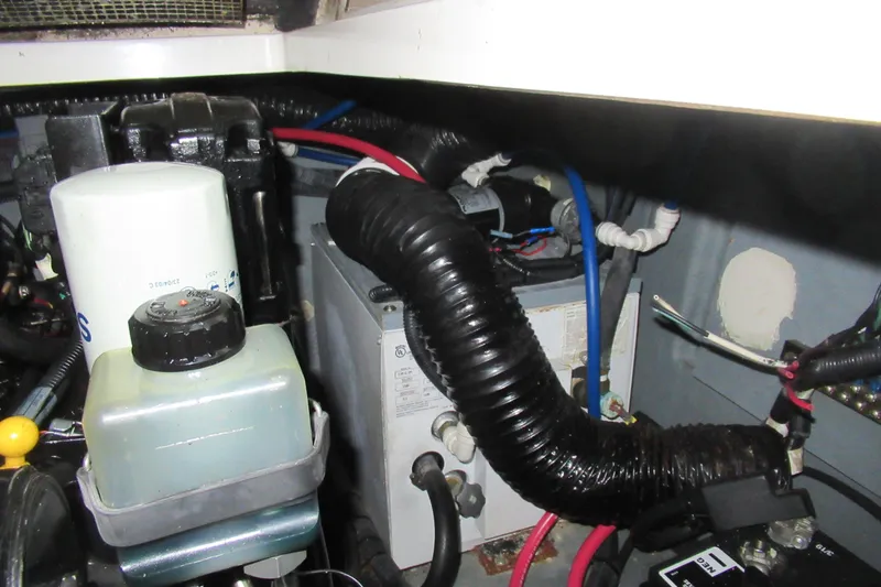 Slide: The Image of Engine compartment of 2001 Searay 280 Sundancer with hoses and components visible. - 82