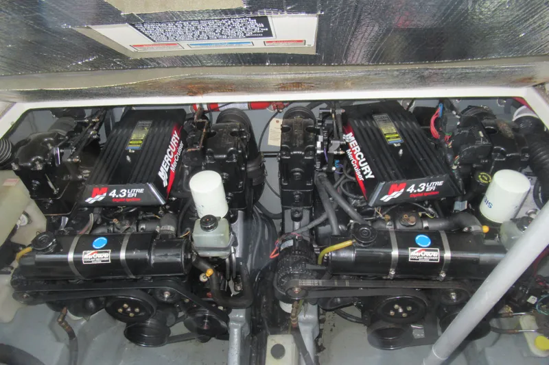 Slide: The Image of Twin Mercury engines in a 2001 Searay 280 Sundancer boat engine compartment. - 85