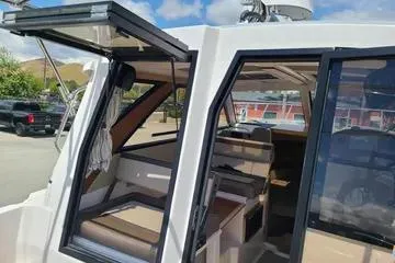 Slide: The Image of 2023 Cutwater C-248 Coupe boat interior with open doors, showcasing seating and dashboard. - 10