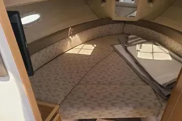 Slide: The Image of 2023 Cutwater C-248 Coupe interior cabin with cozy seating and natural light. - 4