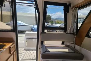 Slide: The Image of Interior view of 2023 Cutwater C-248 Coupe boat, showcasing seating and deck area. - 6