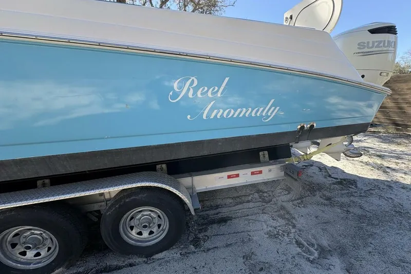 Slide: The Image of 2008 Wellcraft 35 Scarab Sport boat on trailer, featuring "Reet Anomaly" name. - 102
