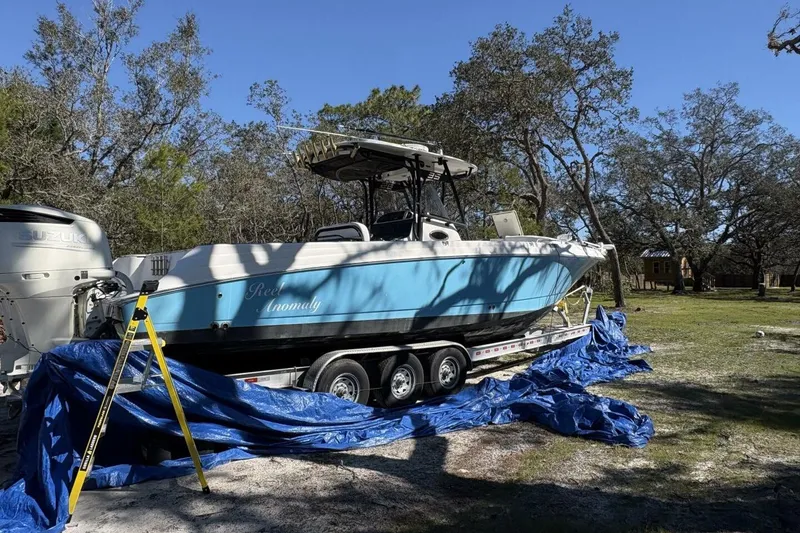 Slide: The Image of 2008 Wellcraft 35 Scarab Sport boat on trailer, parked outdoors with blue tarp. - 111