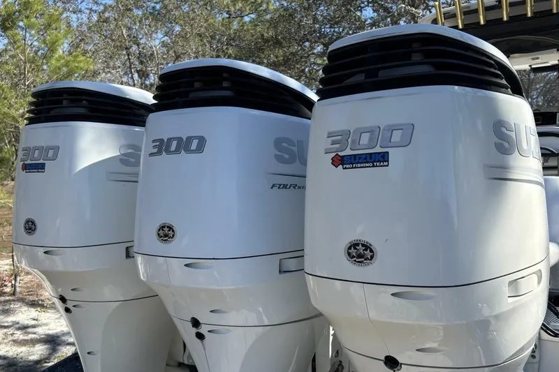 Slide: The Image of Triple Suzuki 300 outboard engines on a 2008 Wellcraft 35 Scarab Sport boat. - 112