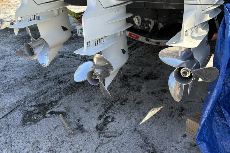 Slide: The Image of 2008 Wellcraft 35 Scarab Sport boat propellers on sandy ground. - 113